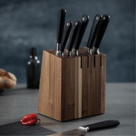 Kuhn Culinary Forged Eight-Piece Acacia Knife Block Set with black-handled knives in warm-toned acacia wood block, styled on kitchen counter