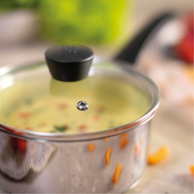 Kuhn Classic Induction Three-Piece Saucepan Set with vented glass lid, stainless steel body, filled with vegetable soup