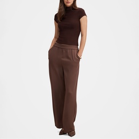 Model wearing Forever New chocolate wide-leg trousers with elasticated waist, styled with a matching brown cap-sleeve top.