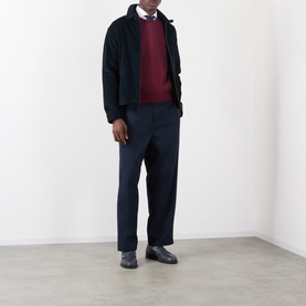 Model wearing Thom Browne burgundy cotton sweatshirt, styled with navy jacket, tailored trousers and black leather shoes.