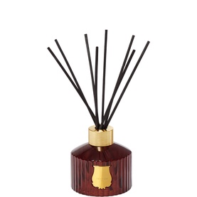 Trudon reed diffuser in deep burgundy ribbed glass bottle with gold collar and black reeds