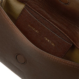 Brown pebbled leather bag interior showing multiple card slots, gold-tone branding stamp, and structured lining