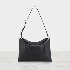 Black leather shoulder bag with front pocket, gold-tone hardware, and single flat strap, displayed on marble surface