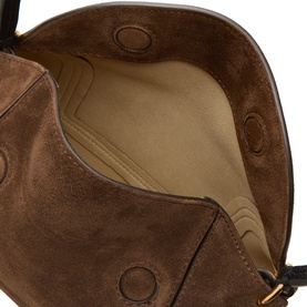 Interior view of brown suede bag showing beige lining, suede panels, and circular press-stud details with gold hardware