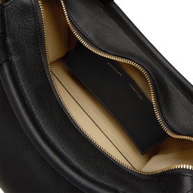 Black leather bag with gold zip, open to reveal beige fabric interior with zip pocket