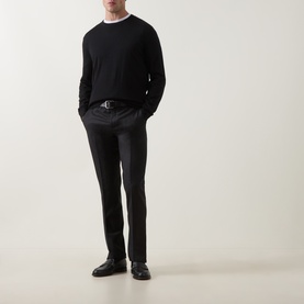 Model wearing Zegna black cashmere-silk polo jumper with slim dark trousers, leather belt and black dress shoes.