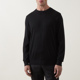 Model wearing Zegna black cashmere-silk crew neck knit jumper with ribbed cuffs and hem, styled with dark trousers.