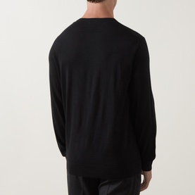 Model wearing Zegna black cashmere-silk polo knitwear, rear view, styled with black trousers.