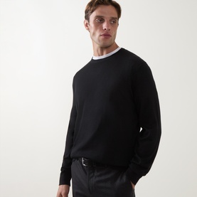 Model wearing Zegna black cashmere-silk polo sweater with crew neck and white collar detail, styled with dark trousers