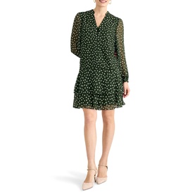 Model wearing Phase Eight green polka dot long-sleeve mini dress with V-neck and pleated skirt, styled with nude heels