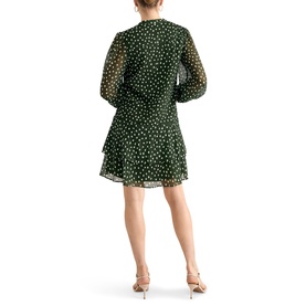 Model wearing Phase Eight green polka dot long-sleeve mini dress with tiered ruffle hem, shown from behind, styled with nude heeled sandals.