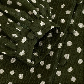 Phase Eight green polka dot dress fabric detail, showing textured crinkle finish with white spot print