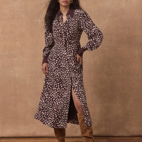 Model wearing Mint Velvet red leopard print midi dress with long sleeves, V-neck, front split, styled with tan ankle boots.