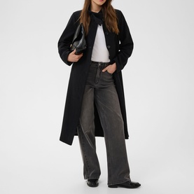 Model wearing Kaffe Black Deep longline coat with double-breasted buttons, styled with white tee, grey wide-leg jeans, carrying black clutch bag