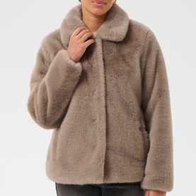 Model wearing Kaffe Rosa Faux Fur Jacket in Taupe Gray, featuring soft stand collar and plush cocoon silhouette with button fastening.