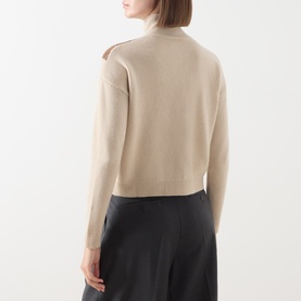 Model wearing Max Mara Studio Ecru wool cashmere cardigan, back view, styled with black wide-leg trousers