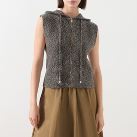 Model wearing Max Mara Studio Gela Zip Knitted Vest in kaki, chunky-knit, hood with drawstring, front zip, styled with khaki wide-leg trousers