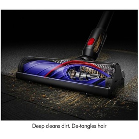 Dyson V8 Cyclone Vacuum Cleaner motorised floor head close-up, showing anti-tangle brush bar in action on hard floor surface.