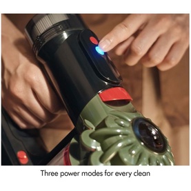 Dyson V8 Cyclone Vacuum Cleaner power button being pressed, showing illuminated blue LED indicator with three power mode controls visible.