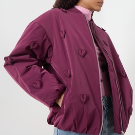 Model wearing Fabienne Chapot Hearty 3D Heart Appliqu&eacute; Bomber Jacket in Brigitte Bordeaux with tonal 3D heart appliqu&eacute;s, styled with pink top and