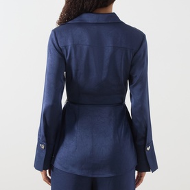 Model wearing Fabienne Chapot Maritime Blue satin-finish belted blazer-style shirt, rear view, with matching blue trousers.