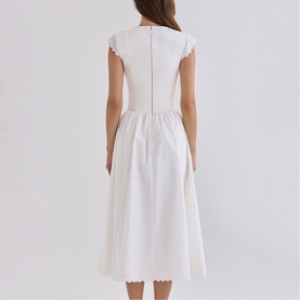 Model wearing House of CB white midi dress, back view, scallop trim neckline and hem, cap sleeves, fitted bodice with full skirt