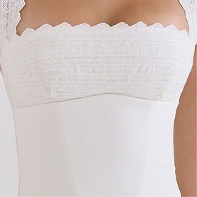 Model wearing House of CB white bandeau top with lace trim detail across the chest and adjustable straps.