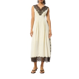 Model wearing Whistles midi dress in cream polka dot with dark lace V-neckline trim and hem, styled with black flat sandals