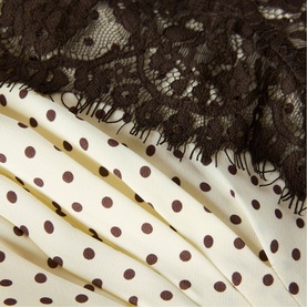 Whistles womenswear dress detail showing cream and brown polka dot fabric with dark brown floral lace trim overlay