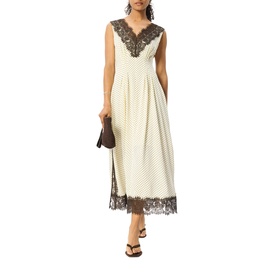 Model wearing Whistles midi dress in cream with black polka dots, lace V-neckline and hem trim, styled with dark sandals and clutch bag