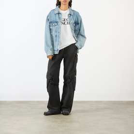 Model wearing Pellador Pigeon Fancier Graphic T-Shirt in white, styled with light blue denim jacket and black cargo trousers.