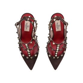 Valentino brown pointed-toe heels with gold pyramid studs, red leather straps, viewed from above showing stud-embellished cage design.