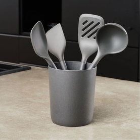 Zyliss grey utensils set including spatula, slotted turner, spoon and ladle stored in a matching grey cylindrical holder.