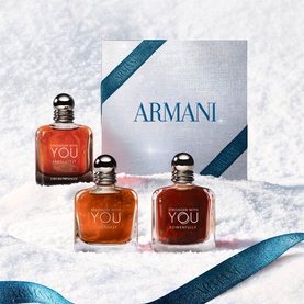 Armani Beauty Stronger With You Intensely Gift Set containing three eau de parfum bottles, presented on snow with blue ribbon and branded box.