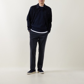 Model wearing Belstaff Bradwell Logo Badge Waffle-Knit Sweater in Dark Ink, styled with navy chinos and dark canvas shoes