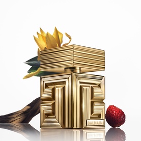 Balmain Parfum in gold sculptural bottle with geometric embossed logo, decorated with sunflower and strawberry accents