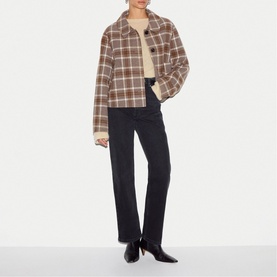 Model wearing Jigsaw cream check wool jacket with black straight-leg trousers and black ankle boots