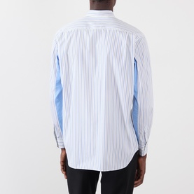Model wearing Comme Des Garcons Shirt blue striped cotton casual shirt, shown from the back with contrast panel detailing.