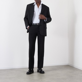 Model wearing Comme Des Garcons Shirt blue cotton casual shirt, styled with black blazer, tailored trousers and chunky loafers.
