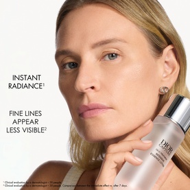 Model with Dior serum held to cheek, with text highlighting instant radiance and reduced fine lines benefits