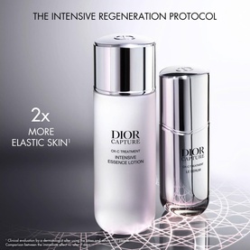 Dior Capture Totale intensive essence lotion and serum duo displayed upright on grey surface, part of regeneration protocol set