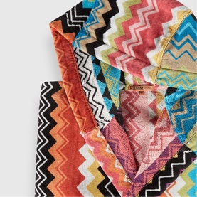 Missoni multi-coloured zigzag patterned towels stacked, featuring bold chevron designs in orange, pink, blue, black and white tones.