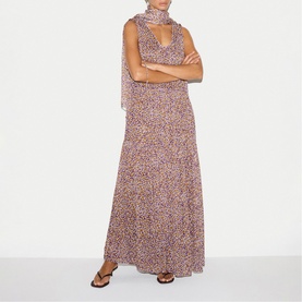 Model wearing Jigsaw purple floral maxi dress with draped scarf neckline, styled with flat brown sandals.