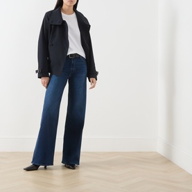 Model wearing Paige Wide Leg Jeans in Admission dark blue denim, styled with a black jacket and white tee, black kitten heel mules.