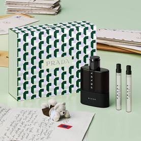 Prada Luna Rossa Black fragrance gift set with geometric print box, large bottle and two travel sprays on mint green background