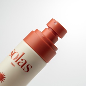 Solas Skin sun care face product in cream bottle with terracotta pump dispenser, close-up detail shot