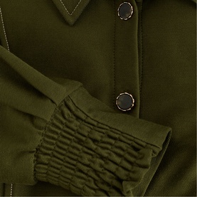 Phase Eight green dress close-up showing ruched cuff detail and gold snap buttons with contrast white stitching