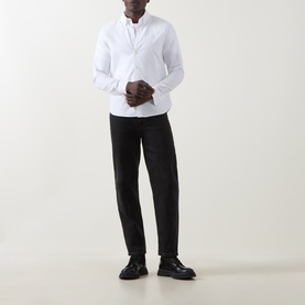 Model wearing Belstaff white cotton casual shirt with black trousers and black leather shoes.