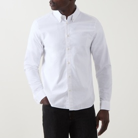 Model wearing Belstaff white cotton casual shirt with button-down collar and chest pocket, styled with black trousers