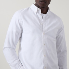Model wearing Belstaff white cotton casual shirt with button-down collar, long sleeves, slim fit silhouette